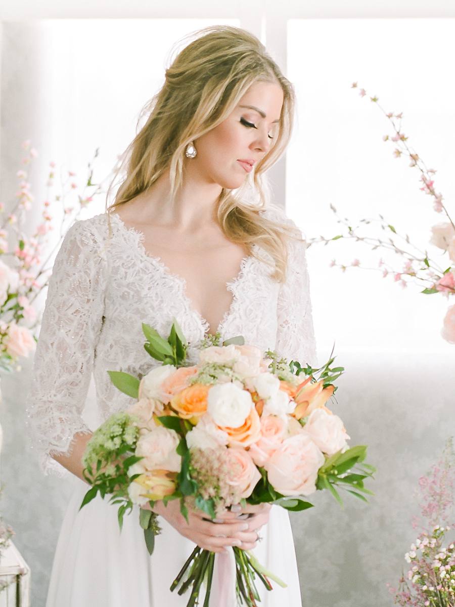 Bride indoor at her wedding with pastel bouquet