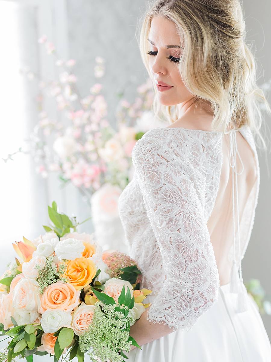 bride indoors with her pastel wedding bouquet in Anchorage