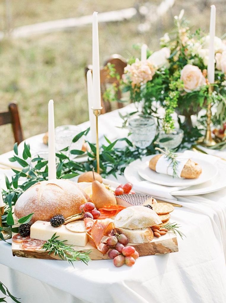 Artisanal Wedding tablescape with greenery and charcuterie boards