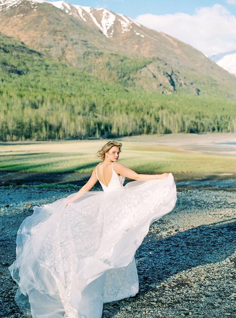 Alaska wedding portrait of bide with her gown flowing in the wind Rachel Tweggs Photography